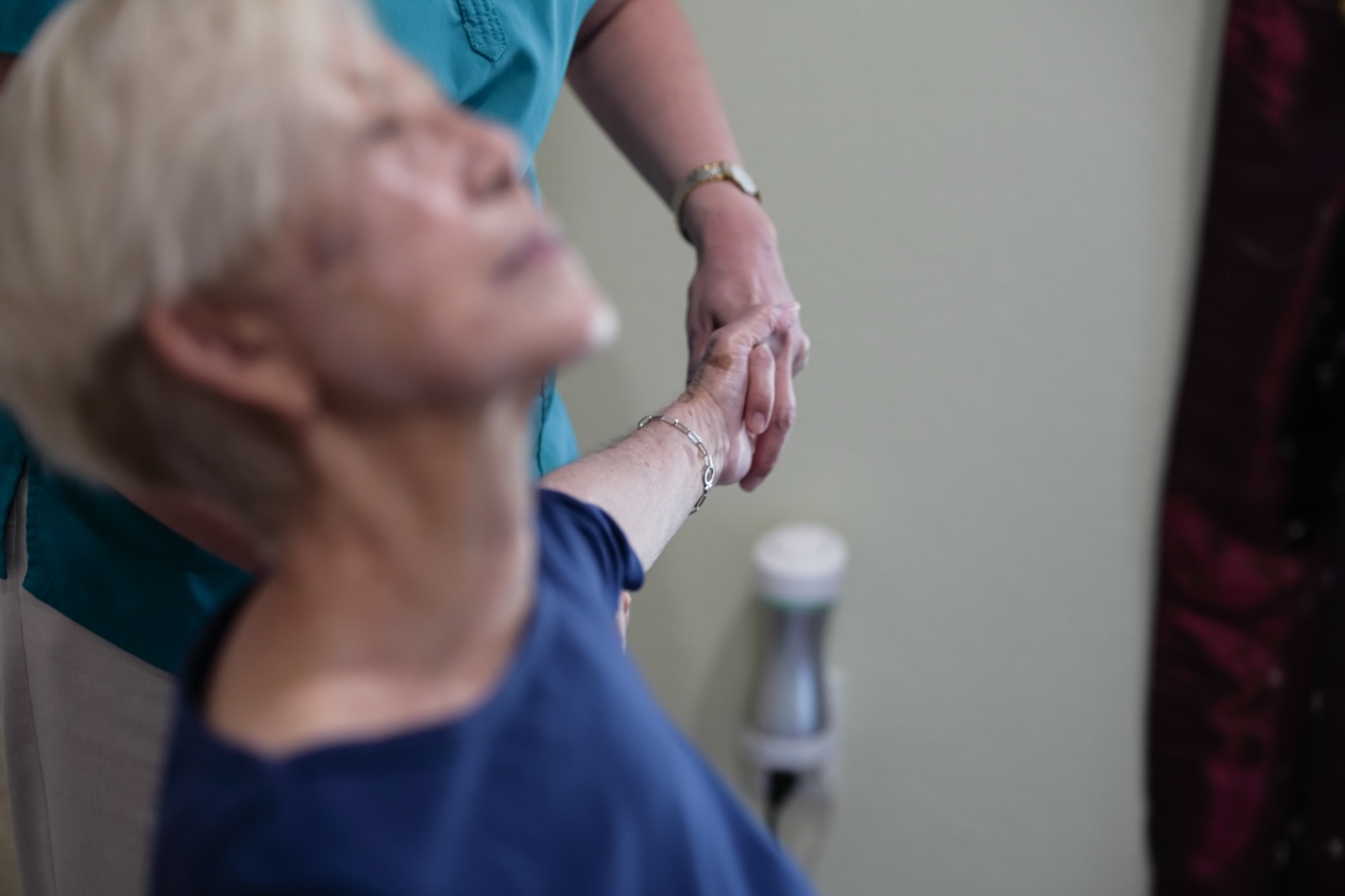 Hands-on therapy — gentle stretching of a patient's arm